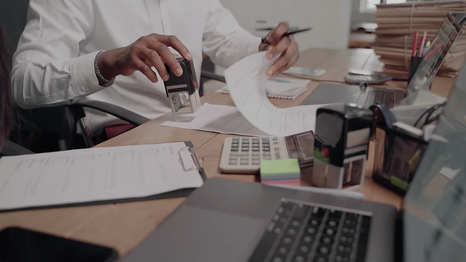 Approvals and receipts being processed at a desk